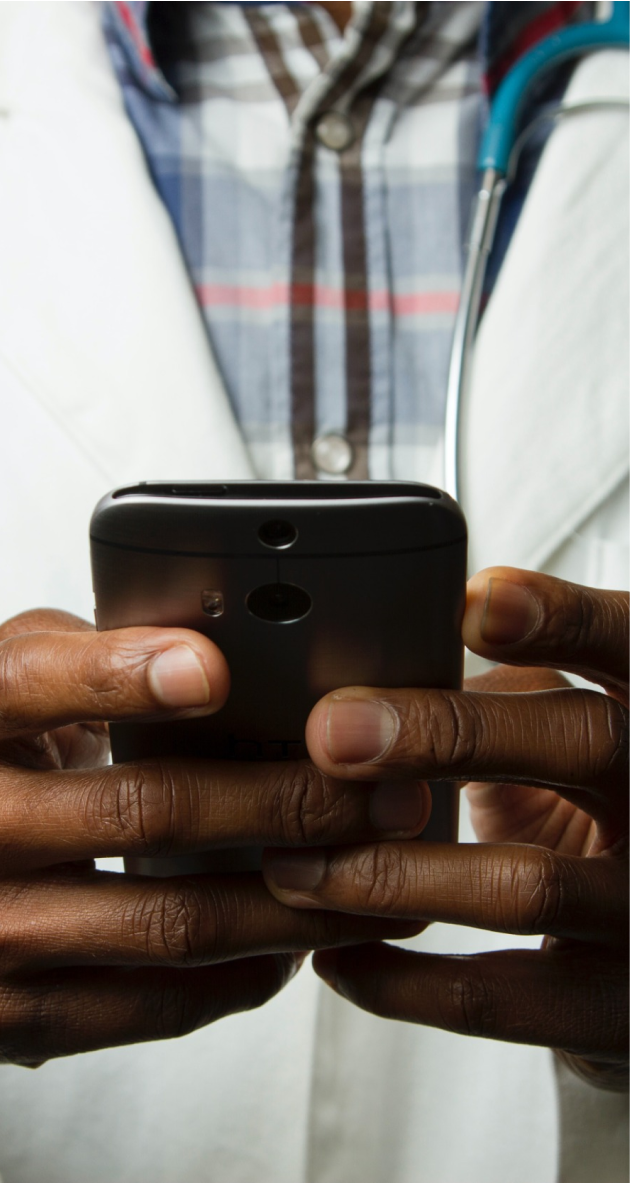 doctor holding phone with sena health app